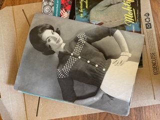A photograph of a woman wearing a cardigan from a vintage knitting magazine