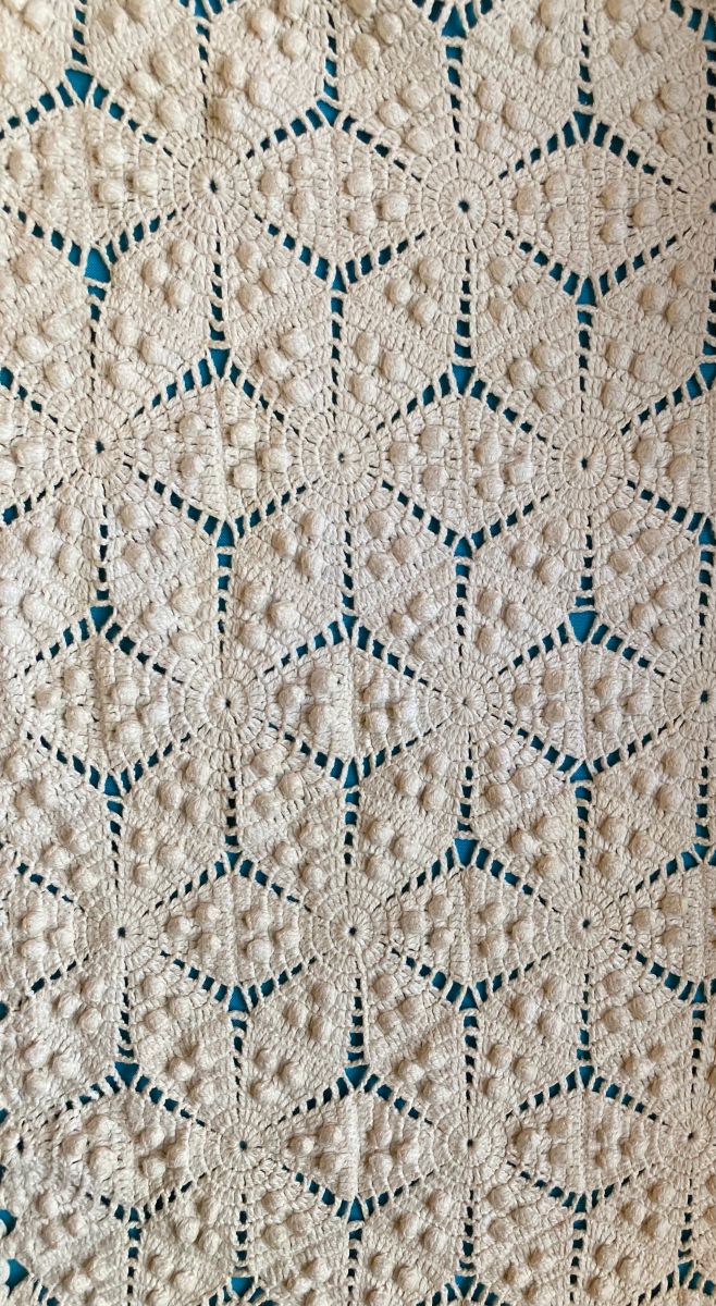 A detail image of a crochet coverlet with a six sided star pattern